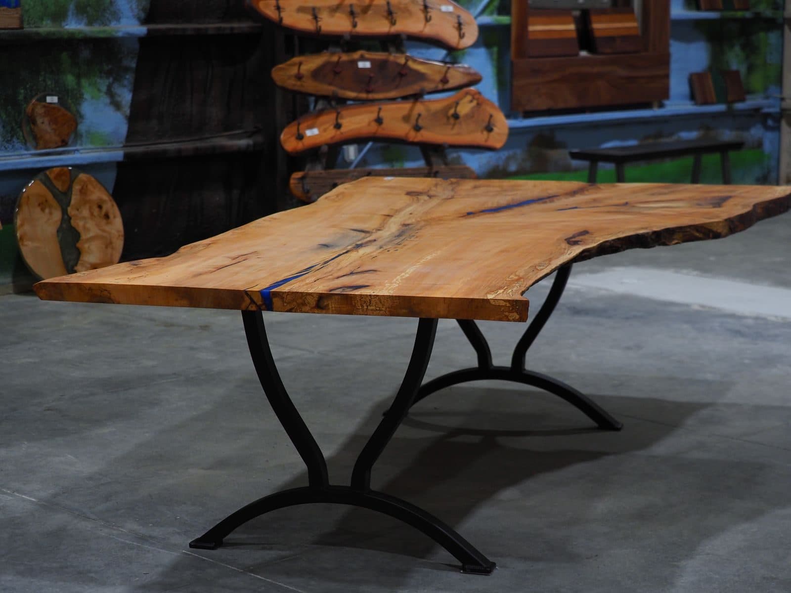 Live-edge dining table staged in the APOC showroom