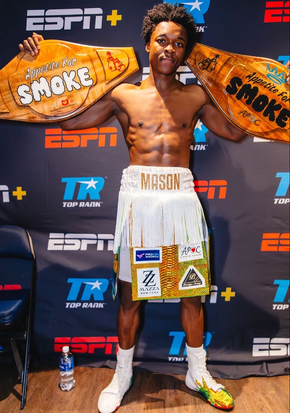 Abdullah Mason with APOC championship belts