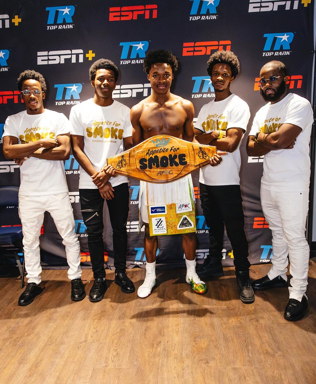 Abdullah Mason and team with the APOC belt